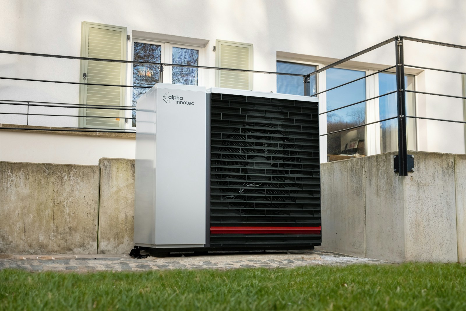 a white air conditioner sitting in front of a building